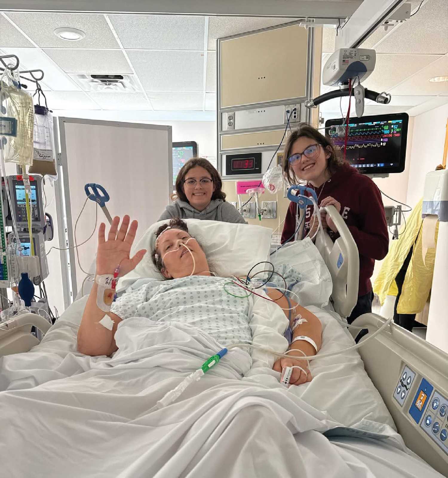 Angela in hospital with her daughters Jayda and Paige.